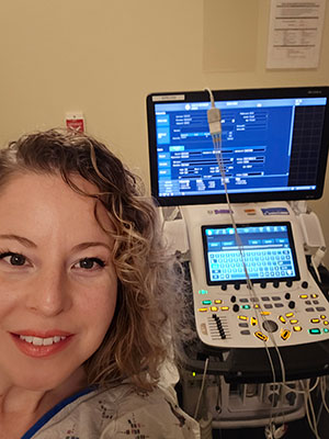 Nichole standing next to medical equipment