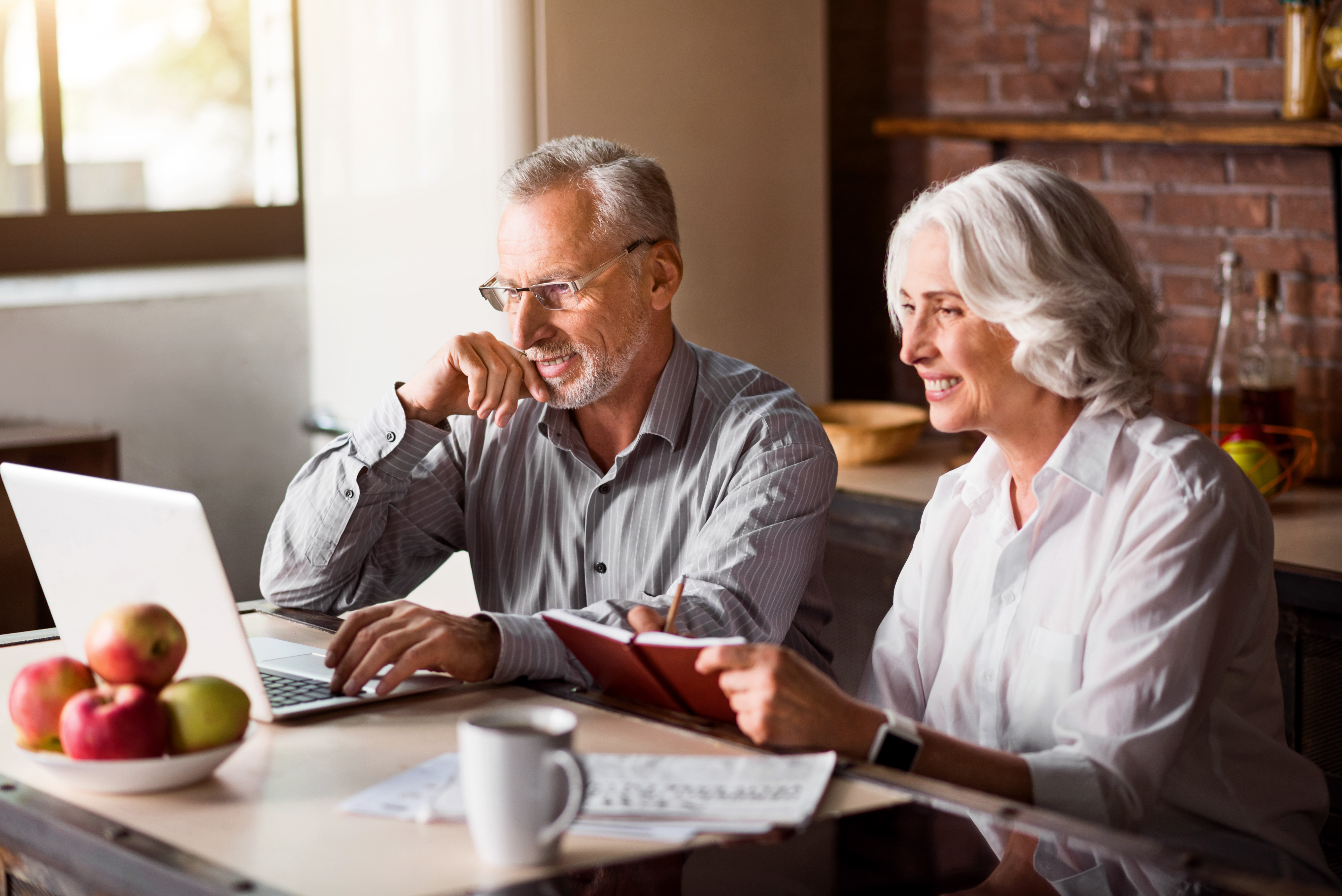 Couple using laptop during breakfast