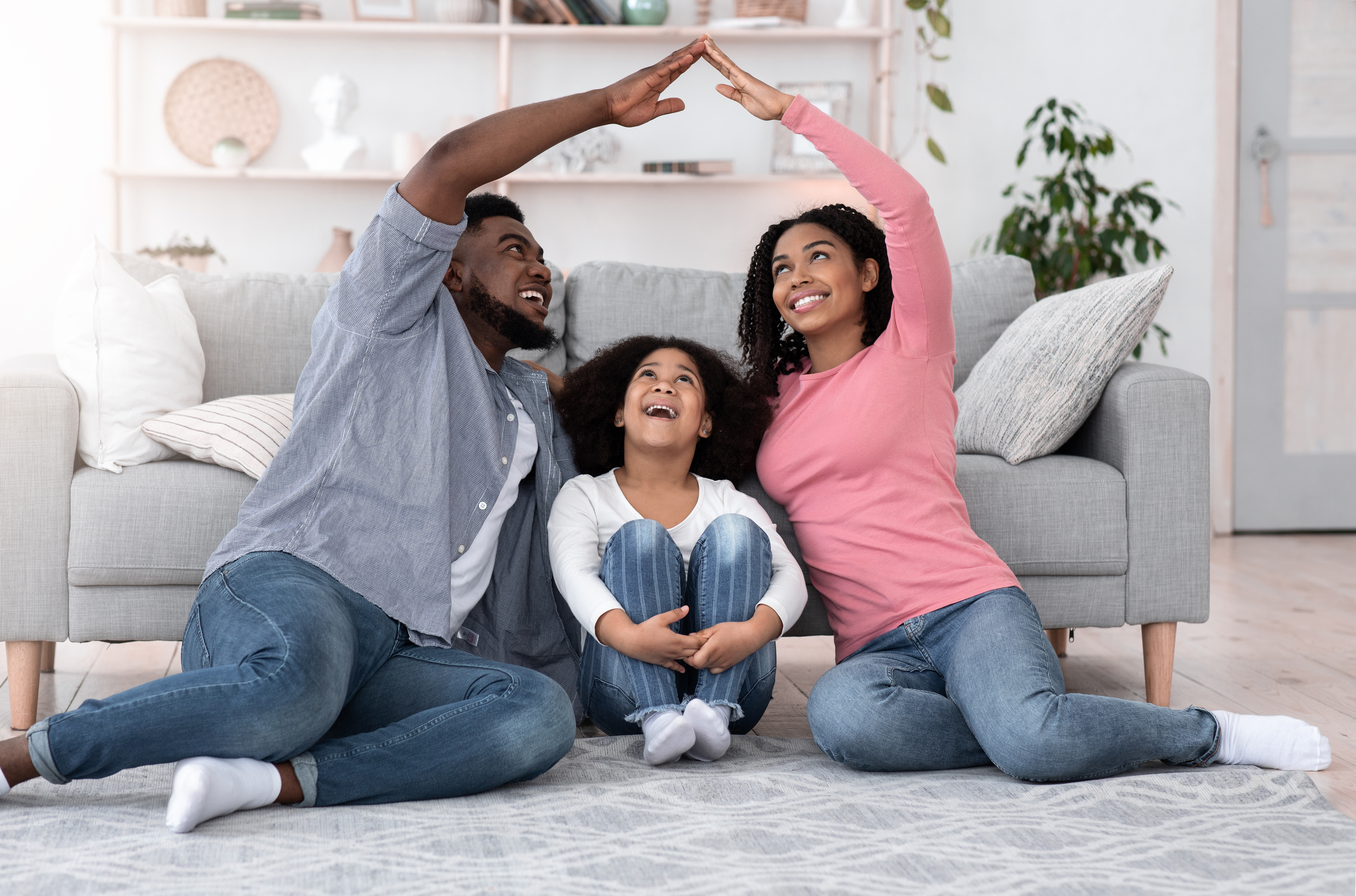 Parents and child having fun in the living room